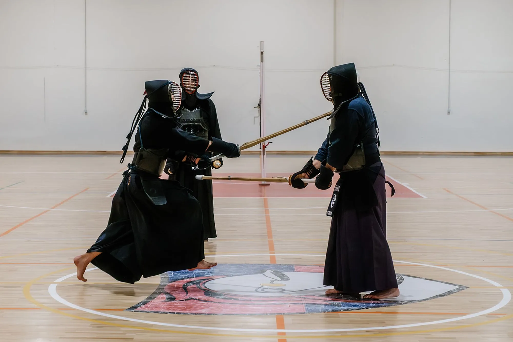 Two kendoka mid-strike over the centre circle