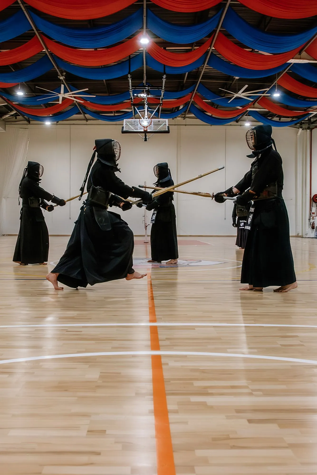 Three kendoka with shinai crossed at close quarters