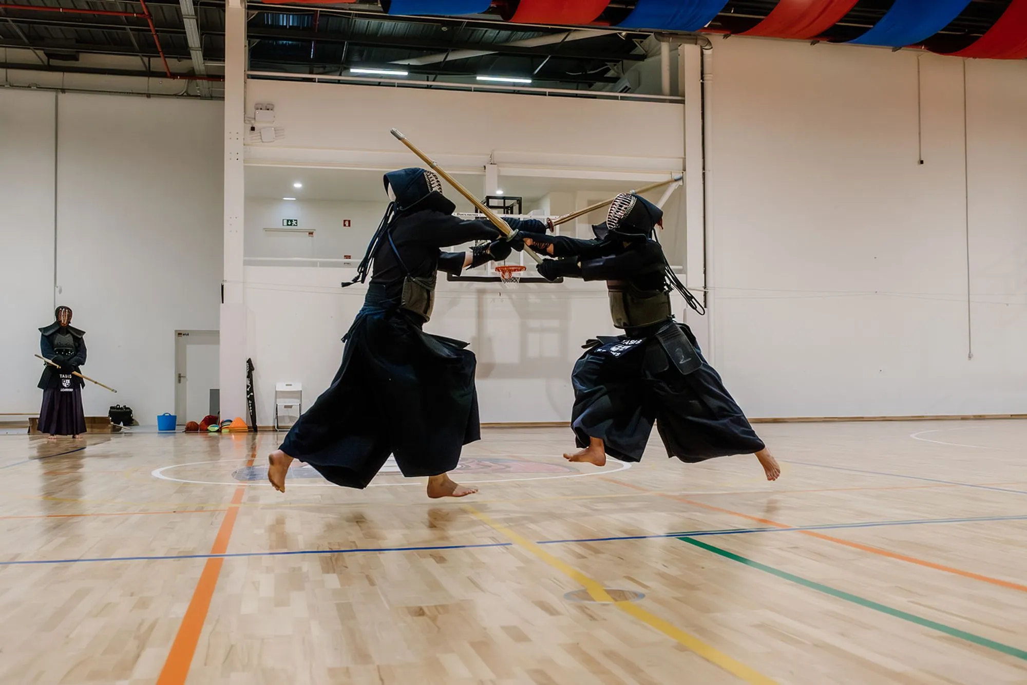 Two kendoka with shinai locked high