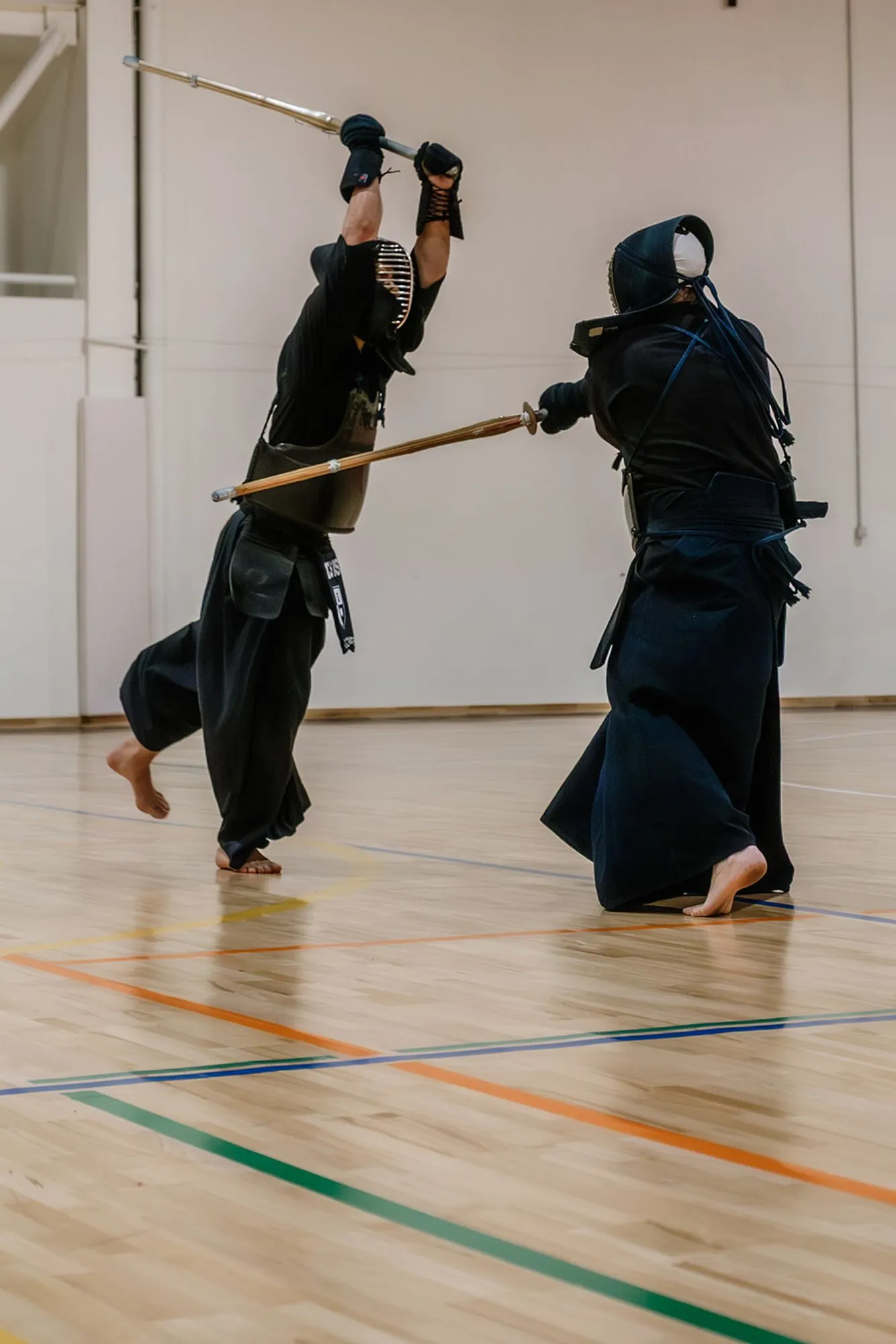 Bare feet and shinai on the wooden floor during a drill