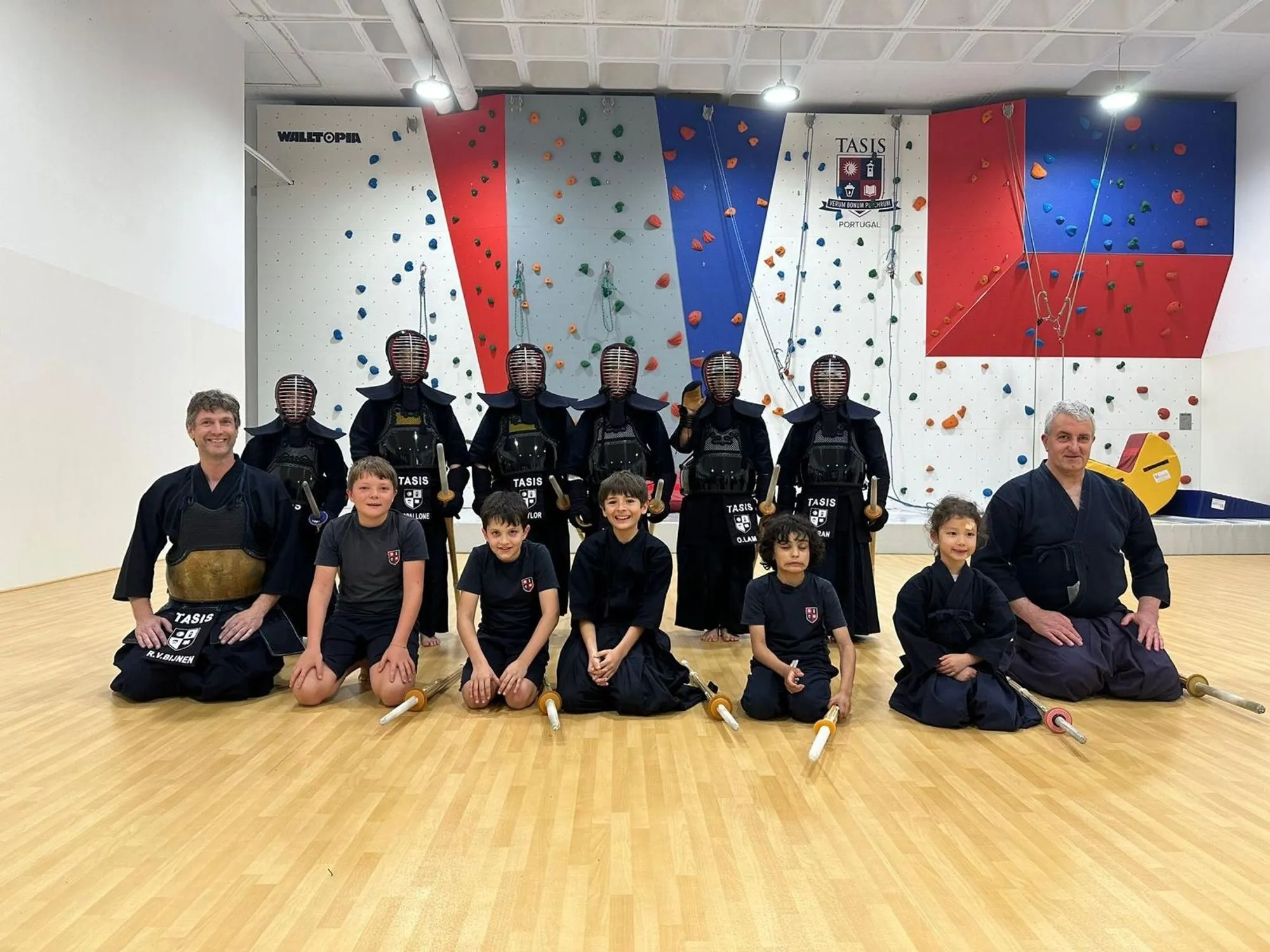 Club group photo, kendoka seated and kneeling together