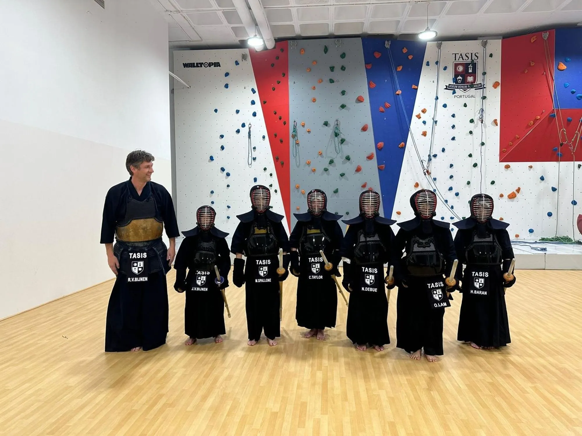 Club group photo, young kendoka standing in bogu
