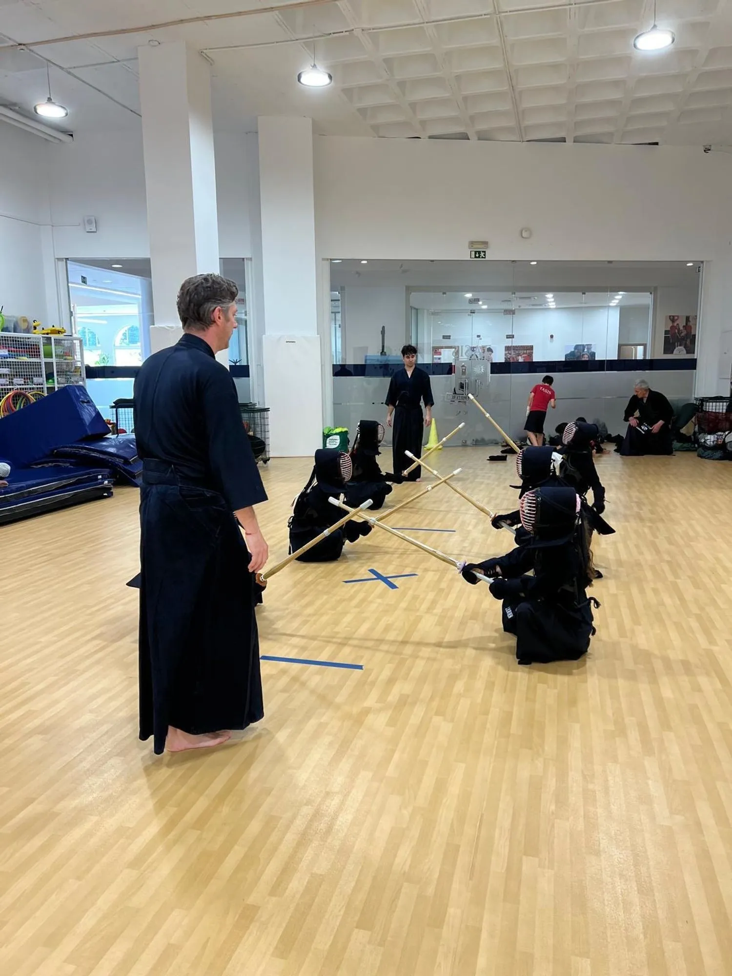 An instructor watching a match from the side