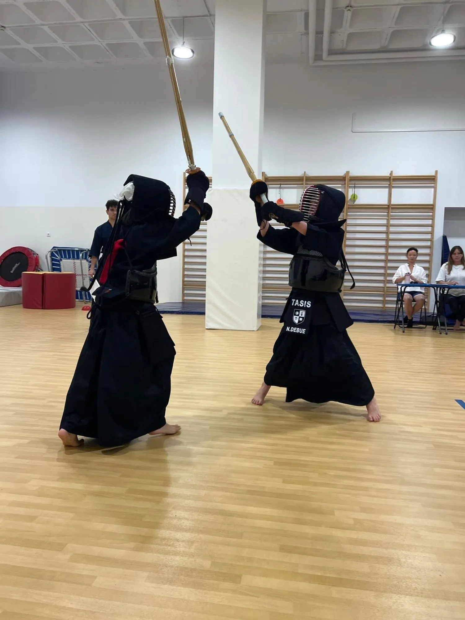 Two young kendoka facing each other in bogu