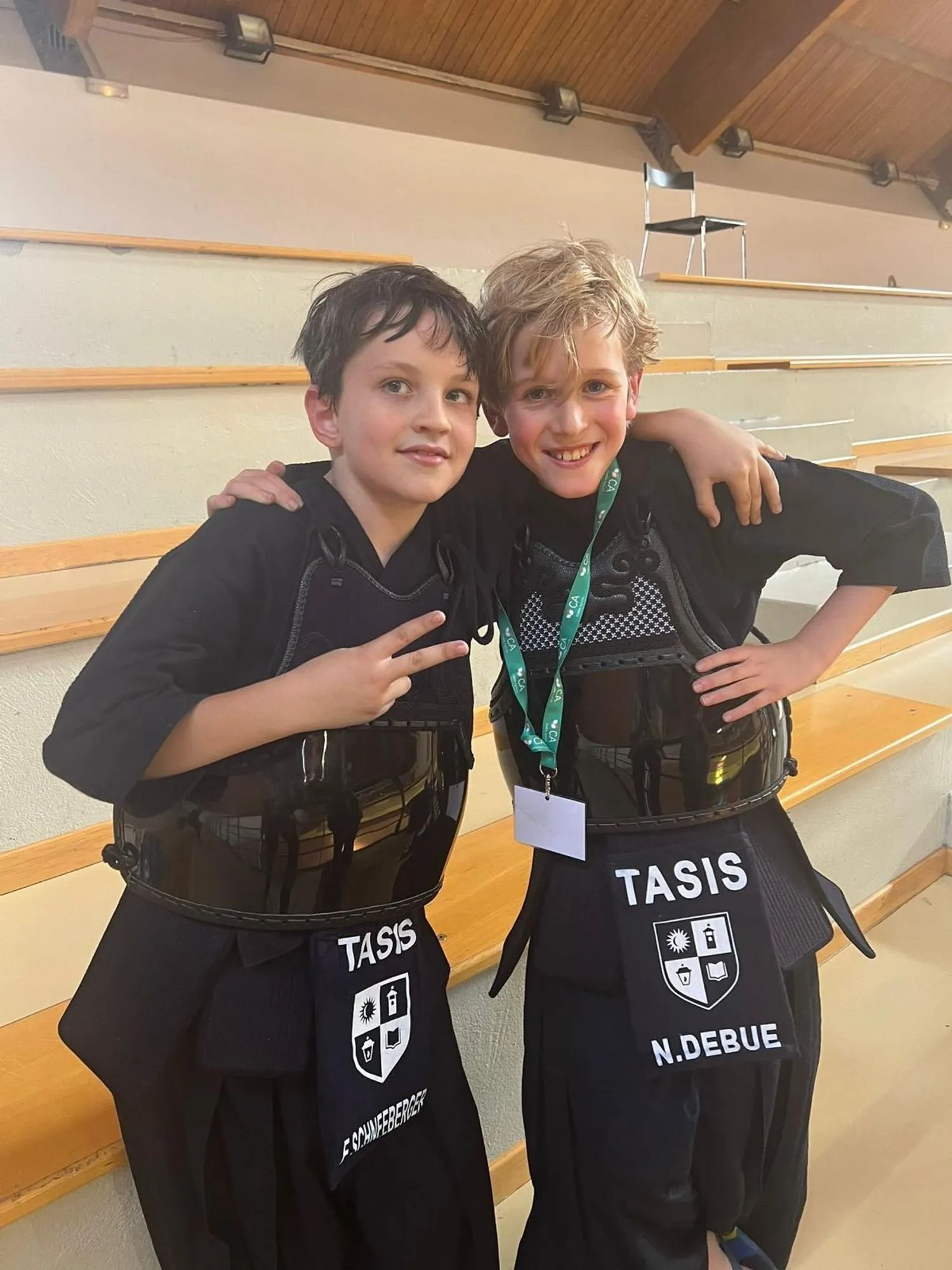 Two young club members smiling after their matches